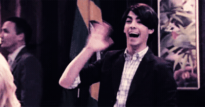 Man In Suit And Plaid Shirt Waving GIF