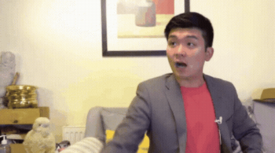 Man In Suit And Red Shirt Standing In Front Of Picture GIF