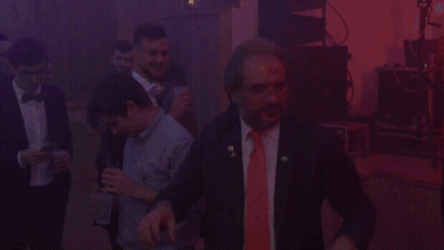 Man In Suit And Red Tie In Dark Room GIF