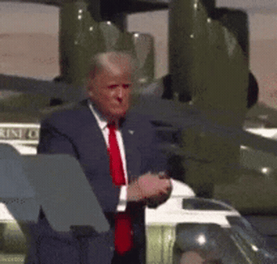 Man In Suit And Red Tie In Front Of Plane Saying United States Of America GIF