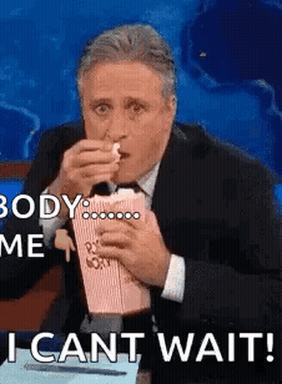 Man In Suit And Red Tie Sitting In Front Of World Map GIF