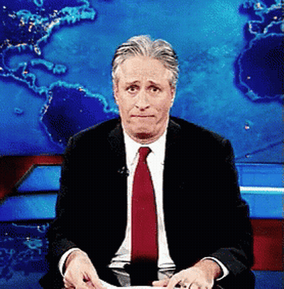 Man In Suit And Red Tie Sitting In Front Of World Map GIF