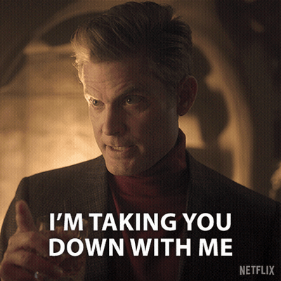 Man In Suit And Red Turtleneck Saying Taking You Down GIF