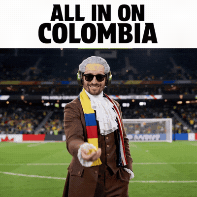 Man In Suit And Scarf Pointing All In On Colombia GIF