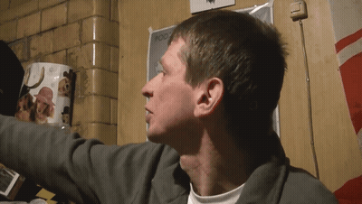 Man In Suit And Shorts Adjusting Sunglasses On Bench GIF