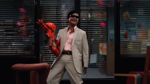 Man In Suit And Sunglasses Holding Inflatable Tigger GIF