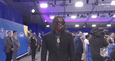 Man In Suit And Sunglasses In Front Of Crowd GIF