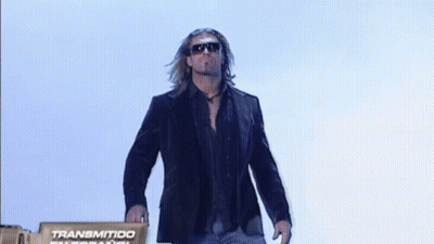 Man In Suit And Sunglasses In Front Of Transmitido International Sign GIF