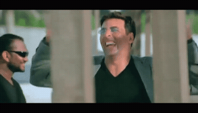 Man In Suit And Sunglasses Laughing Next To Man In Black Shirt GIF