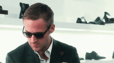 Man In Suit And Sunglasses Looking Down GIF