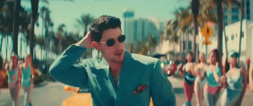 Man In Suit And Sunglasses On Street With Group Of Women GIF