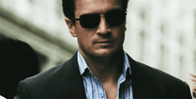 Man In Suit And Sunglasses Walking Down Street GIF