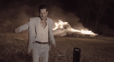 Man In Suit And Suspenders Before Burning Car GIF