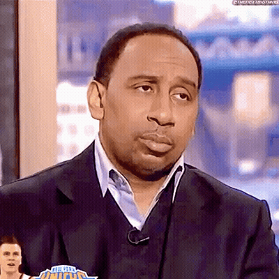 Man In Suit And Sweater On TV Show GIF