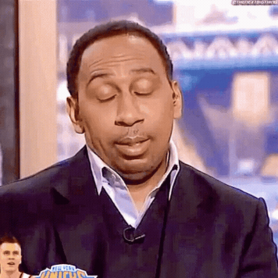 Man In Suit And Sweater On TV Show GIF