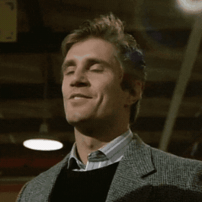 Man In Suit And Sweater Smiling At Camera GIF