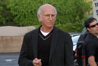 Man In Suit And Sweater With The Sign GIF