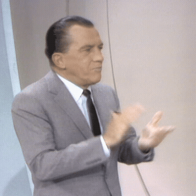 Man In Suit And Tie Applauding Hands Outstretched GIF