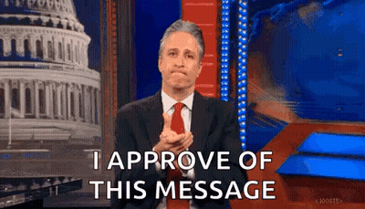 Man In Suit And Tie Applauding In Front Of Building GIF