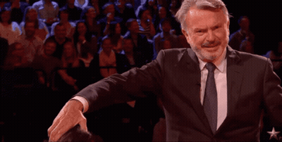 Man In Suit And Tie Arms Outstretched Crowd GIF
