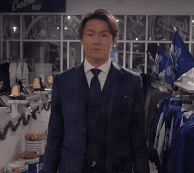 Man In Suit And Tie At Custom Shop Sign GIF