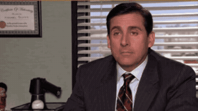 Man In Suit And Tie At Desk By Window GIF