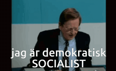 Man In Suit And Tie At Desk Jag Ar Demokratisk Socialist GIF