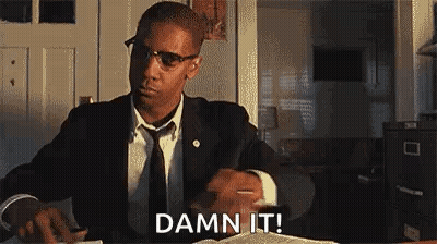 Man In Suit And Tie At Desk With Book And Pen GIF