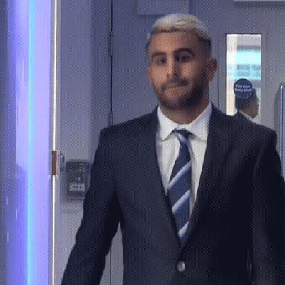 Man In Suit And Tie At Fire Door GIF