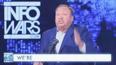 Man In Suit And Tie At Microphone With M GIF