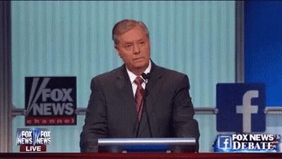 Man In Suit And Tie At Podium With Fox News Sign GIF