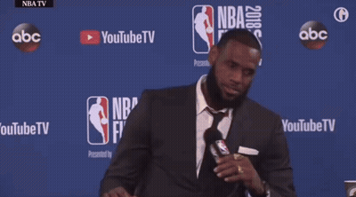 Man In Suit And Tie At Table With NBA Finals GIF
