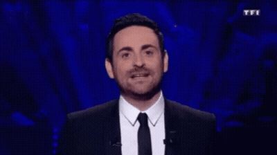 Man In Suit And Tie At TFI Sign GIF