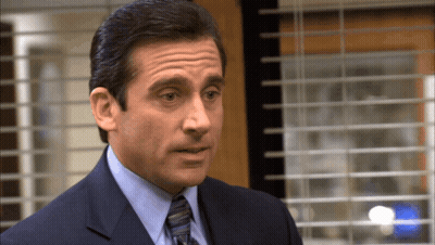 Man In Suit And Tie At Window GIF