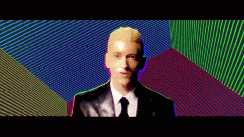 Man In Suit And Tie Before Colorful Wall GIF
