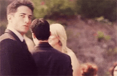 Man In Suit And Tie Before Woman In White GIF