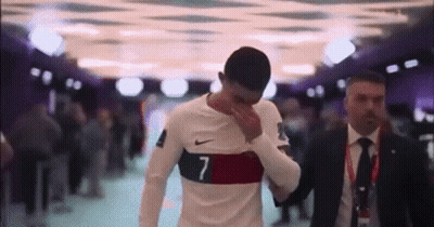 Man In Suit And Tie Beside Soccer Player GIF
