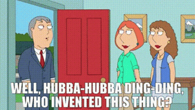 Man In Suit And Tie By Red Door With Two Women GIF