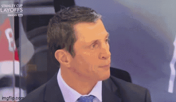 Man In Suit And Tie By Stanley Cup Layoffs Banner GIF