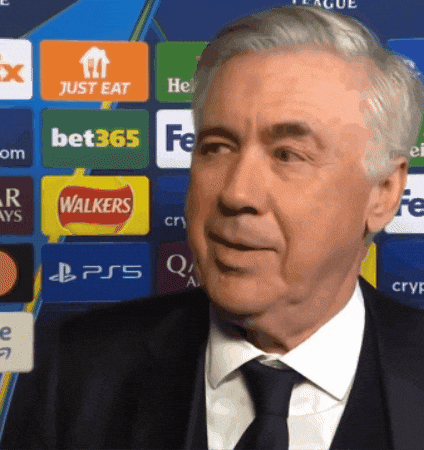 Man In Suit And Tie By Wall With Walkers And Bet365 Logos GIF
