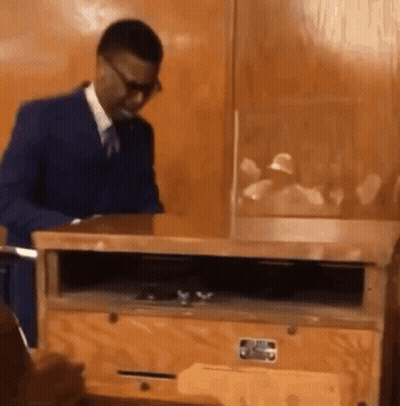 Man In Suit And Tie By Wooden Box GIF
