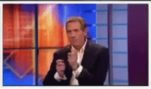 Man in Suit and Tie Clapping Hands