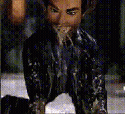 Man In Suit And Tie Covered In White Liquid GIF