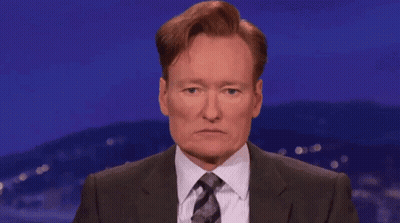 Man In Suit And Tie Covering Eyes GIF