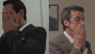 Man In Suit And Tie Covering Face GIF