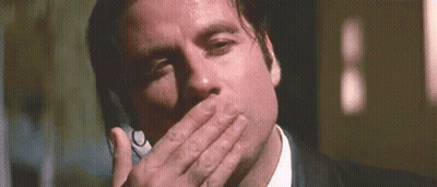 Man In Suit And Tie Covering Mouth On Phone GIF