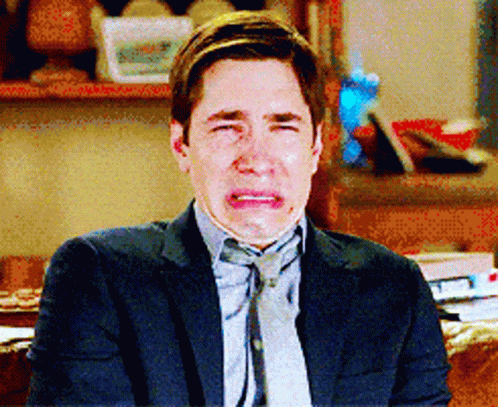 Man In Suit And Tie Crying On Couch GIF