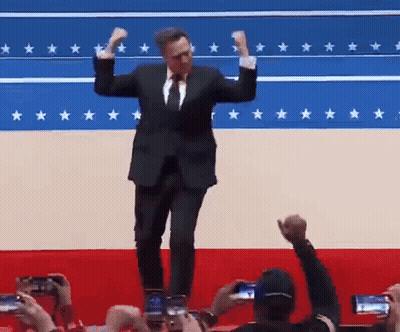 Man In Suit And Tie Dancing Before Star Flag GIF