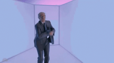Man In Suit And Tie Dancing In Cube GIF