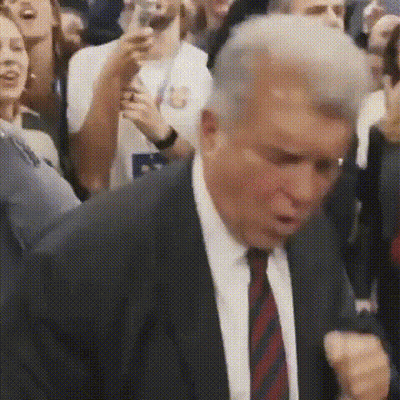 Man In Suit And Tie Dancing In Front Of Crowd GIF